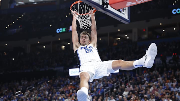 Orlando Magic forward Franz Wagner (22) hangs on the basket after dunking against the Oklahoma City Thunder during the second quarter at Paycom Center.