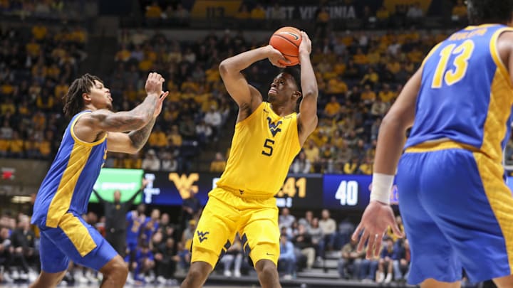 Nov 13, 2025; Morgantown, West Virginia, USA; West Virginia Mountaineers forward DJ Thomas (5) shoots during the second half against the Pittsburgh Panthers at WVU Coliseum. Mandatory Credit: Ben Queen-Imagn Images