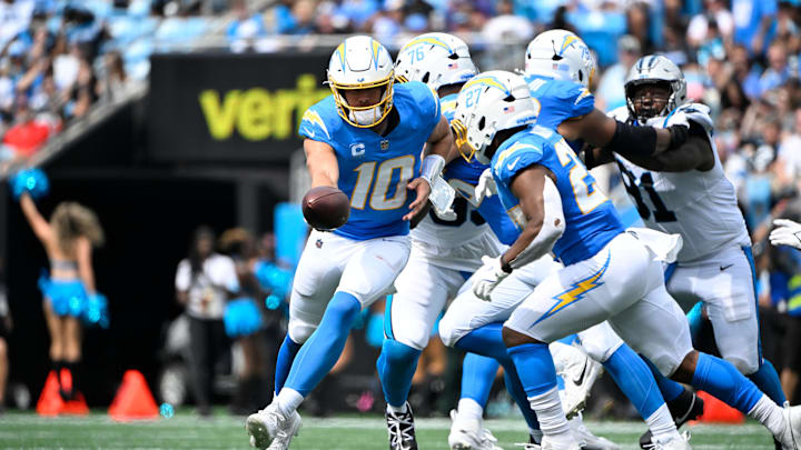 Sep 15, 2024; Charlotte, North Carolina, USA; Los Angeles Chargers quarterback Justin Herbert (10) hands the ball off to running back J.K. Dobbins (27) in the third quarter at Bank of America Stadium. Mandatory Credit: Bob Donnan-Imagn Images Sep 15, 2024; Charlotte, North Carolina, USA; Los Angeles Chargers quarterback Justin Herbert (10) hands the ball off to running back J.K. Dobbins (27) in the third quarter at Bank of America Stadium. Mandatory Credit: Bob Donnan-Imagn Images