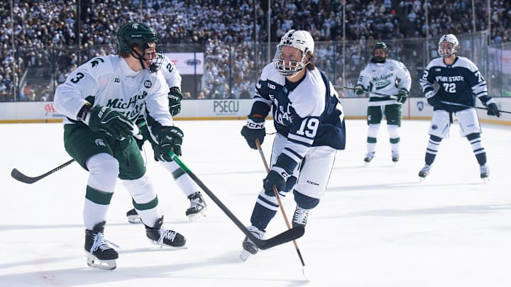 Penn State forward Dane Dowiak (19) passes the puck during a Big Ten ice hockey game against Michigan State in Beaver Stadium on January 31, 2026.