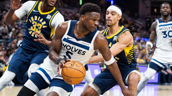 Mar 24, 2025; Indianapolis, Indiana, USA; Minnesota Timberwolves guard Anthony Edwards (5) dribbles the ball while Indiana Pacers center Myles Turner (33) and  guard Andrew Nembhard (2) defend in the first half at Gainbridge Fieldhouse. Mandatory Credit: Trevor Ruszkowski-Imagn Images
