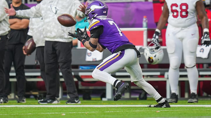 Dec 1, 2024; Minneapolis, Minnesota, USA; Minnesota Vikings cornerback Byron Murphy Jr. (7) intercepts the ball against the Arizona Cardinals in the fourth quarter at U.S. Bank Stadium. Mandatory Credit: Brad Rempel-Imagn Images