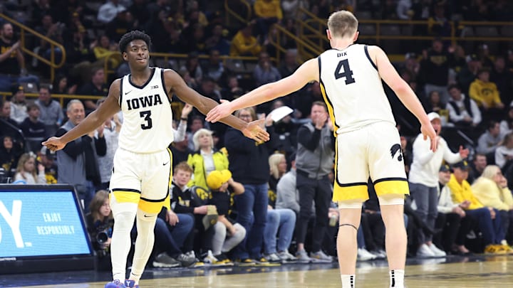 Jan 24, 2025; Iowa City, Iowa, USA; Iowa Hawkeyes guard Josh Dix (4) and Iowa Hawkeyes guard Drew Thelwell (3) celebrate against the Penn State Nittany Lions during the first half at Carver-Hawkeye Arena. Mandatory Credit: Reese Strickland-Imagn Images