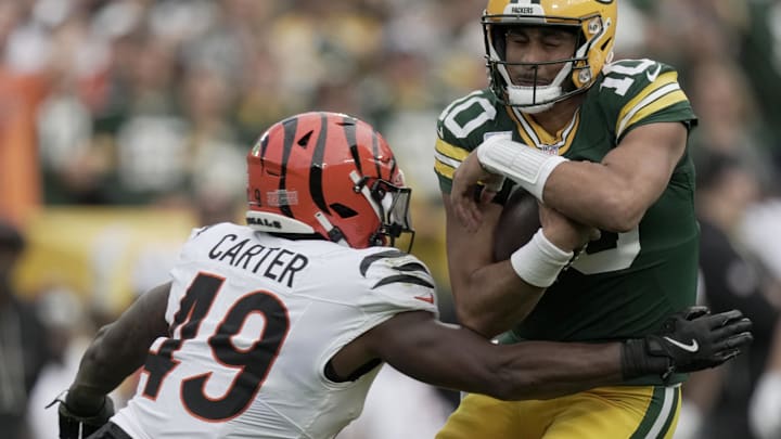 Oct 12, 2025; Green Bay, Wisconsin, USA; Cincinnati Bengals linebacker Barrett Carter (49) sacks Green Bay Packers quarterback Jordan Love (10) during the second quarter of their game at Lambeau Field. Mandatory Credit: Mark Hoffman-USA TODAY Network via Imagn Images