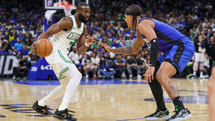 Boston Celtics guard Jaylen Brown (7) handles the ball in front of Orlando Magic forward Paolo Banchero (5) during the second half of game three of first round for the 2024 NBA Playoffs at Kia Center.