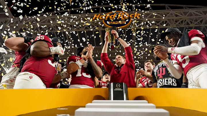 Indiana Hoosiers head coach Curt Cignetti hoists the championship trophy Monday, Jan. 19, 2026, after defeating the Miami (FL) Hurricanes in the College Football Playoff National Championship college football game at Hard Rock Stadium in Miami Gardens.