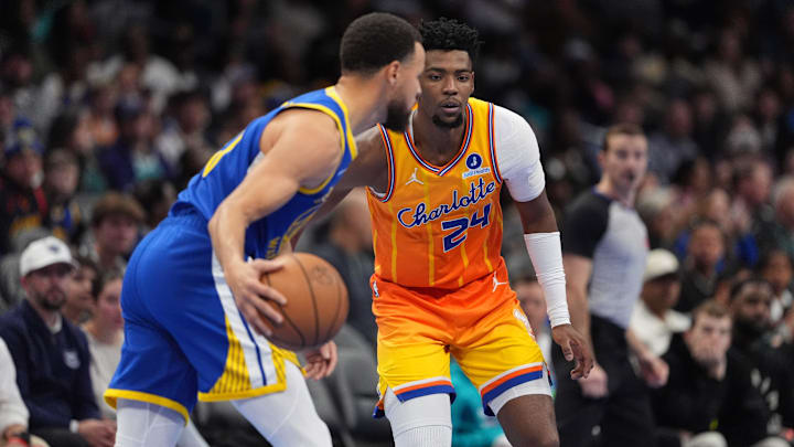 Dec 31, 2025; Charlotte, North Carolina, USA; Charlotte Hornets forward Brandon Miller (24) defends against Golden State Warriors guard Stephen Curry (30) during the second quarter at Spectrum Center. Mandatory Credit: Jim Dedmon-Imagn Images