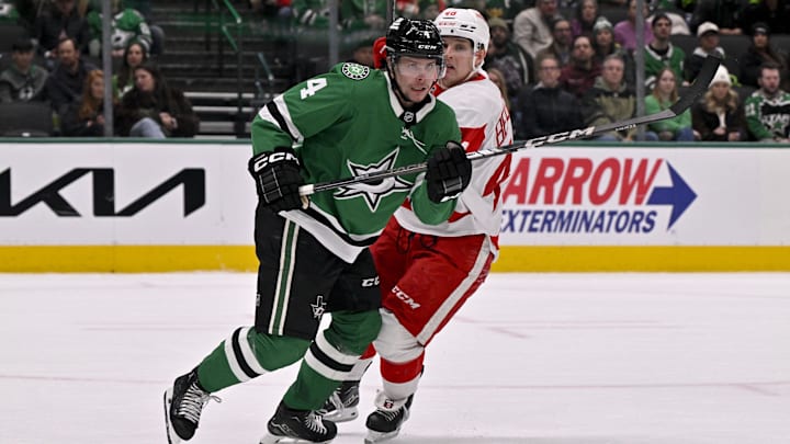 Jan 19, 2025; Dallas, Texas, USA; Dallas Stars defenseman Miro Heiskanen (4) and Detroit Red Wings right wing Jonatan Berggren (48) chase the puck during the third period at the American Airlines Center. Mandatory Credit: Jerome Miron-Imagn Images