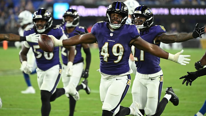 Aug 7, 2025; Baltimore, Maryland, USA; Baltimore Ravens linebacker Jay Higgins IV (49) celebrates after an interception against the Indianapolis Colts during the fourth quarter at M&T Bank Stadium. Mandatory Credit: Rafael Suanes-Imagn Images