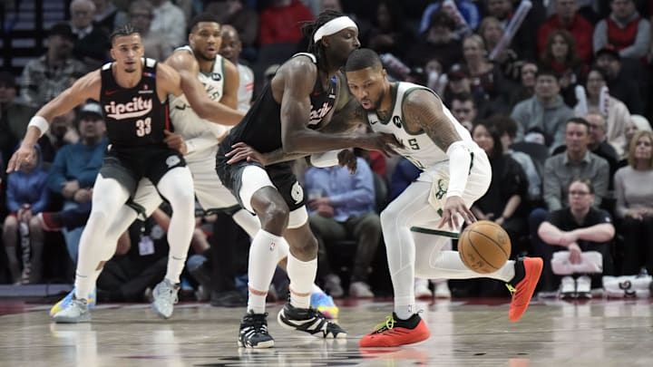 Jan 28, 2025; Portland, Oregon, USA: Milwaukee Bucks point guard Damian Lillard (0) dribbles the ball against Portland Trail Blazers small forward Jerami Grant (9, left) during the first half at Moda Center. Mandatory Credit: Soobum Im-Imagn Images Jan 28, 2025; Portland, Oregon, USA: Milwaukee Bucks point guard Damian Lillard (0) dribbles the ball against Portland Trail Blazers small forward Jerami Grant (9, left) during the first half at Moda Center. Mandatory Credit: Soobum Im-Imagn Images