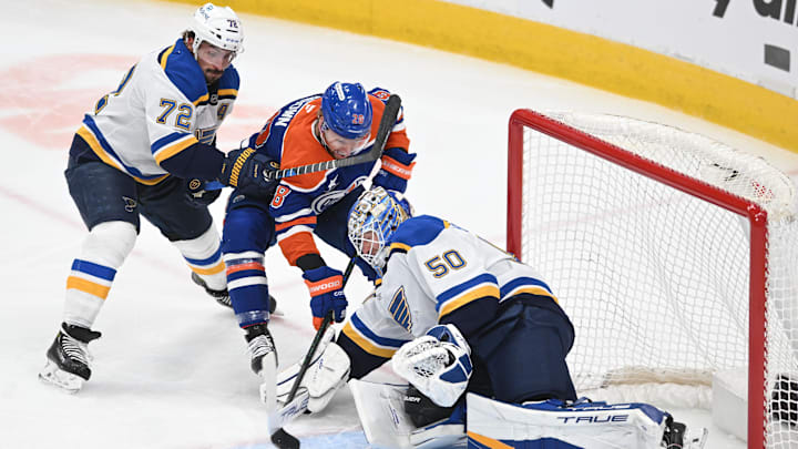 Apr 9, 2025; Edmonton, Alberta, CAN; St. Louis Blues defenseman Justin Faulk (72) checks Edmonton Oilers right wing Connor Brown (28) in front of Blues goalie Jordan Binnington (50) during the first period at Rogers Place. Mandatory Credit: Walter Tychnowicz-Imagn Images