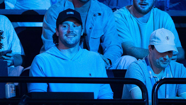 Buffalo Bills quarterback Josh Allen, bottom left, and Minnesota Vikings quarterback Sam Darnold, top right, attend the TGL match between Jupiter Links GC and Atlanta Drive GC at SoFi Center on March 4, 2025, in Palm Beach Gardens, Florida.