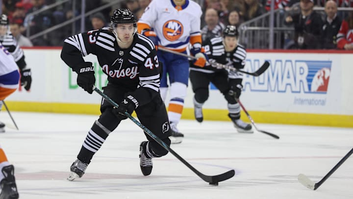 Apr 13, 2025; Newark, New Jersey, USA; New Jersey Devils defenseman Luke Hughes (43) skates with the puck against the New York Islanders during the second period at Prudential Center. Mandatory Credit: Ed Mulholland-Imagn Images