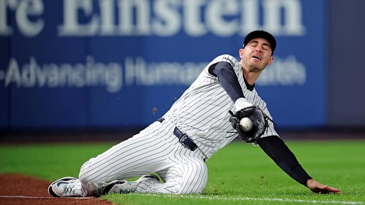 Oct 8, 2025; Bronx, New York, USA; New York Yankees left fielder Cody Bellinger (35) slides to makes a catch during the first inning against the Toronto Blue Jays during game four of the ALDS round for the 2025 MLB playoffs at Yankee Stadium. Mandatory Credit: Brad Penner-Imagn Images