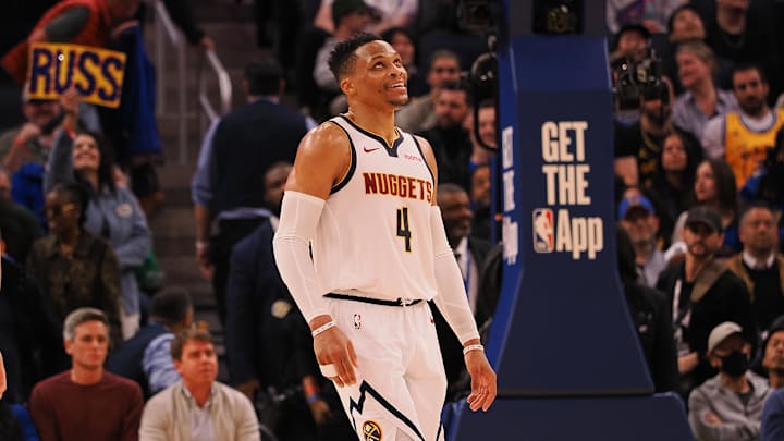 Mar 17, 2025; San Francisco, California, USA; Denver Nuggets guard Russell Westbrook (4) smiles ahead of a sign reading “Russ” after a play against the Golden State Warriors during the fourth quarter at Chase Center. Mandatory Credit: Kelley L Cox-Imagn Images Mar 17, 2025; San Francisco, California, USA; Denver Nuggets guard Russell Westbrook (4) smiles ahead of a sign reading “Russ” after a play against the Golden State Warriors during the fourth quarter at Chase Center. Mandatory Credit: Kelley L Cox-Imagn Images