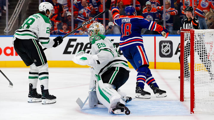 May 25, 2025; Edmonton, Alberta, CAN; Edmonton Oilers left wing Zach Hyman (18) celebrates after he scores a goal against Dallas Stars goaltender Jake Oettinger (29) as defenseman Alexander Petrovic (28) looks on during the third period in game three of the Western Conference Final of the 2025 Stanley Cup Playoffs at Rogers Place. Mandatory Credit: Perry Nelson-Imagn Images