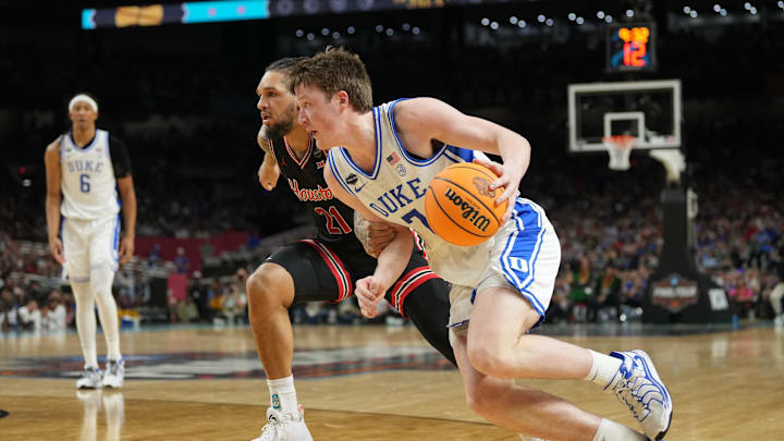 Apr 5, 2025; San Antonio, TX, USA;  Duke Blue Devils guard Kon Knueppel (7) drives against Houston Cougars guard Emanuel Sharp (21) in the semifinals of the men's Final Four of the 2025 NCAA Tournament at the Alamodome. Mandatory Credit: Robert Deutsch-Imagn Images