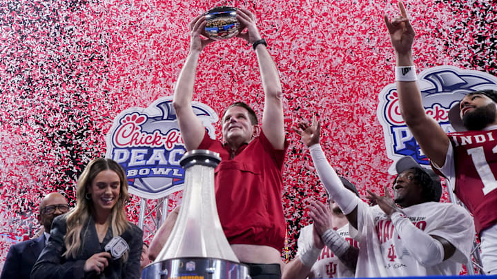 Indiana Hoosiers head coach Curt Cignetti holds up the trophy as confetti falls Friday, Jan. 9, 2026, after defeating the Oregon Ducks in the Peach Bowl and semifinal game of the College Football Playoff at Mercedes-Benz Stadium in Atlanta.