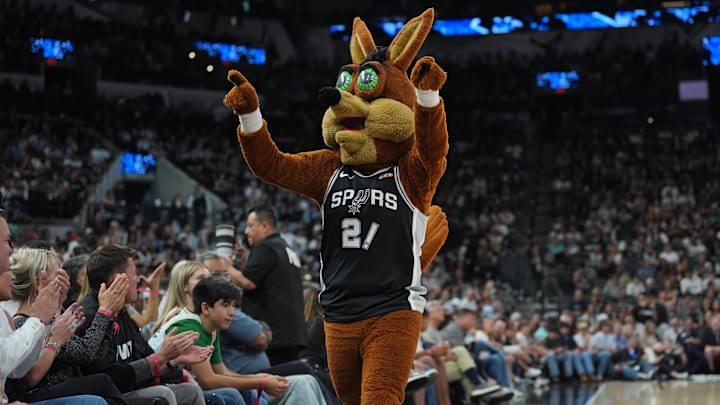 Oct 27, 2025; San Antonio, Texas, USA;  The San Antonio Spurs Coyote performs in the second half against the Toronto Raptors at Frost Bank Center. Mandatory Credit: Daniel Dunn-Imagn Images