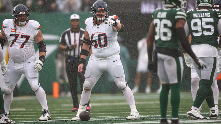 Denver Broncos center Luke Wattenberg (60) points during the first half against the New York Jets at MetLife Stadium.