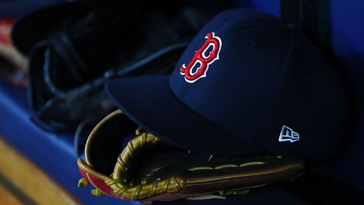 Jul 22, 2019; St. Petersburg, FL, USA; A detail view of Boston Red Sox hat and glove laying in the dugout at Tropicana Field. Mandatory Credit: Kim Klement-Imagn Images