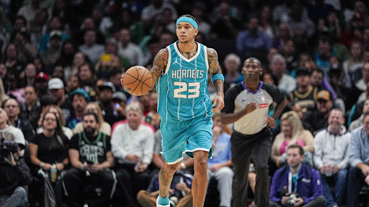 Nov 1, 2024; Charlotte, North Carolina, USA; Charlotte Hornets guard Tre Mann (23) brings the ball up court against the Boston Celtics during the second half at the Spectrum Center. Mandatory Credit: Jim Dedmon-Imagn Images
