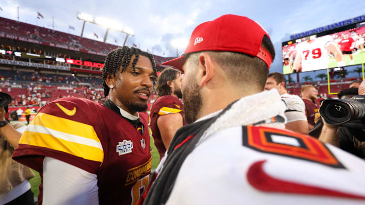 Sep 8, 2024; Tampa, Florida, USA; Washington Commanders quarterback Jayden Daniels (5) greets Tampa Bay Buccaneers quarterback Baker Mayfield (6) after a game at Raymond James Stadium. Mandatory Credit: Nathan Ray Seebeck-Imagn Images