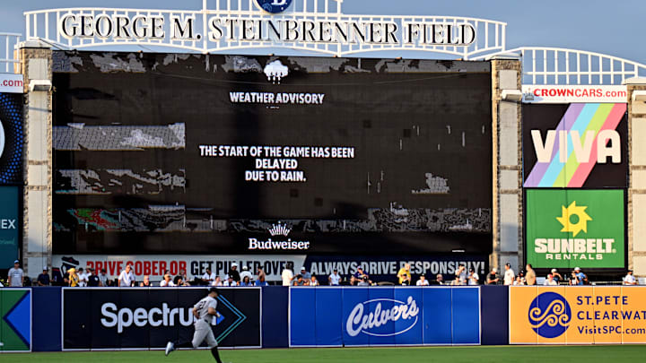 Aug 19, 2025; St. Petersburg, Florida, USA;  New York Yankees right fielder fielder Giancarlo Stanton (27)warms up as the rain delay is announced before  the start of the game against the Tampa Bay Rays at George M. Steinbrenner Field. Mandatory Credit: Jonathan Dyer-Imagn Images