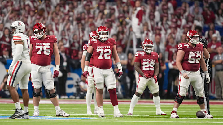 Dec 28, 2023; San Antonio, TX, USA;  Oklahoma Sooners offensive linemen Jacob Sexton (76), McKade Mettauer (72), and Troy Everett (52) get ready for a play in the first half against the Arizona Wildcats at Alamodome. Mandatory Credit: Daniel Dunn-Imagn Images