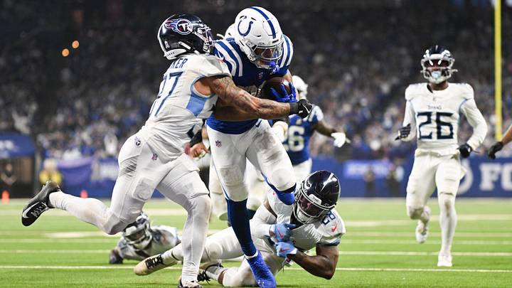 Oct 26, 2025; Indianapolis, Indiana, USA; Indianapolis Colts running back Jonathan Taylor (28) rushes for a touchdown as Tennessee Titans safety Amani Hooker (37) defends during the third quarter at Lucas Oil Stadium. Mandatory Credit: Robert Goddin-Imagn Images