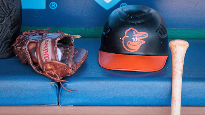 Apr 21, 2024; Kansas City, Missouri, USA; Baltimore Orioles hat and glove sits in the dugout during the ninth inning against the Kansas City Royals at Kauffman Stadium. Mandatory Credit: William Purnell-Imagn Images Apr 21, 2024; Kansas City, Missouri, USA; Baltimore Orioles hat and glove sits in the dugout during the ninth inning against the Kansas City Royals at Kauffman Stadium. Mandatory Credit: William Purnell-Imagn Images