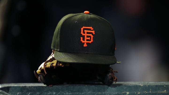 General view of a San Francisco Giants cap and glove during the ninth inning against the Colorado Rockies at Coors Field. General view of a San Francisco Giants cap and glove during the ninth inning against the Colorado Rockies at Coors Field.