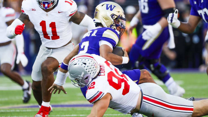 Sep 27, 2025; Seattle, Washington, USA; Ohio State Buckeyes defensive end Caden Curry (92) sacks Washington Huskies quarterback Demond Williams Jr. (2) during the second quarter at Husky Stadium. Mandatory Credit: Joe Nicholson-Imagn Images