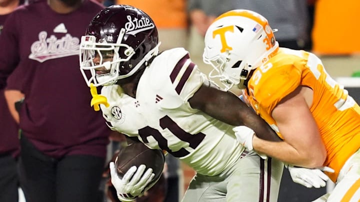 Mississippi State running back Davon Booth (21) tries to escape a tackle by Tennessee defensive back Will Brooks (35) during a game at Neyland Stadium in Knoxville, Tenn.