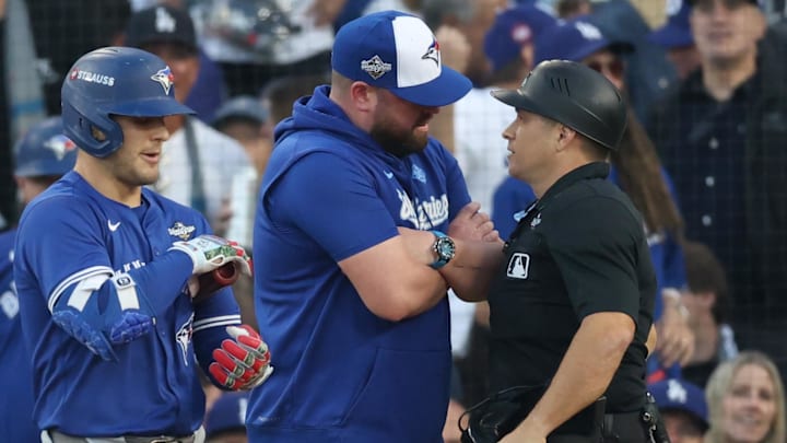Oct 27, 2025; Los Angeles, California, USA; Toronto Blue Jays manager John Schneider (14) talks to home plate umpire Mark Wegner during the second inning against the Los Angeles Dodgers in game three of the 2025 MLB World Series at Dodger Stadium. Mandatory Credit: Kiyoshi Mio-Imagn Images Oct 27, 2025; Los Angeles, California, USA; Toronto Blue Jays manager John Schneider (14) talks to home plate umpire Mark Wegner during the second inning against the Los Angeles Dodgers in game three of the 2025 MLB World Series at Dodger Stadium. Mandatory Credit: Kiyoshi Mio-Imagn Images