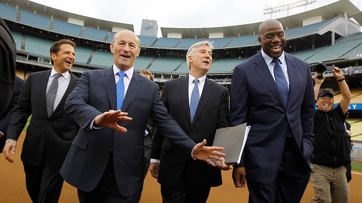 The new Dodger owners, left to right, Peter Guber, Stan Kasten, Mark Walter and Earvin "Magic" John