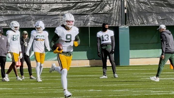 Christian Watson run after the catch at practice on Thursday.
