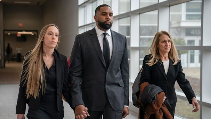 Kelli Moore walks with her husband former University of Michigan coach Sherrone Moore and his attorney Ellen Michaels.