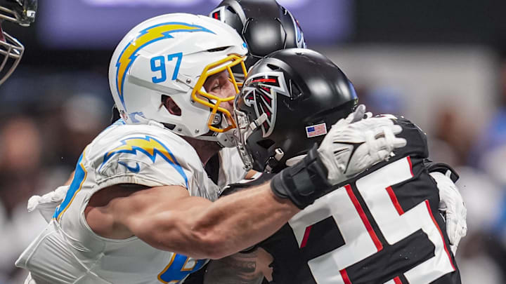 Dec 1, 2024; Atlanta, Georgia, USA; Atlanta Falcons running back Tyler Allgeier (25) is tackled by Los Angeles Chargers linebacker Joey Bosa (97) during the second half at Mercedes-Benz Stadium. Mandatory Credit: Dale Zanine-Imagn Images