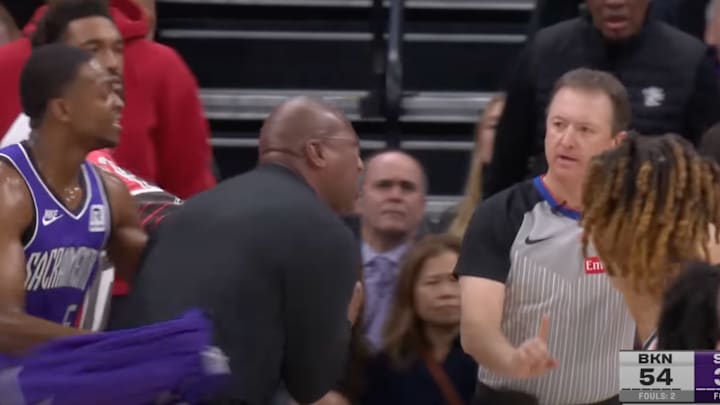 De’Aaron Fox holds back Mike brown from a referee. 