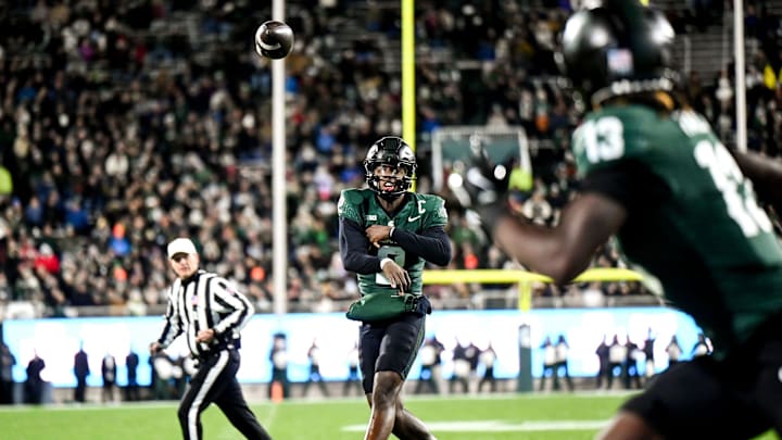 Michigan State's Aidan Chiles, left, throws the ball to Ademola Faleye during the second quarter in the game against Purdue on Friday, Nov. 22, 2024, at Spartan Stadium in East Lansing.