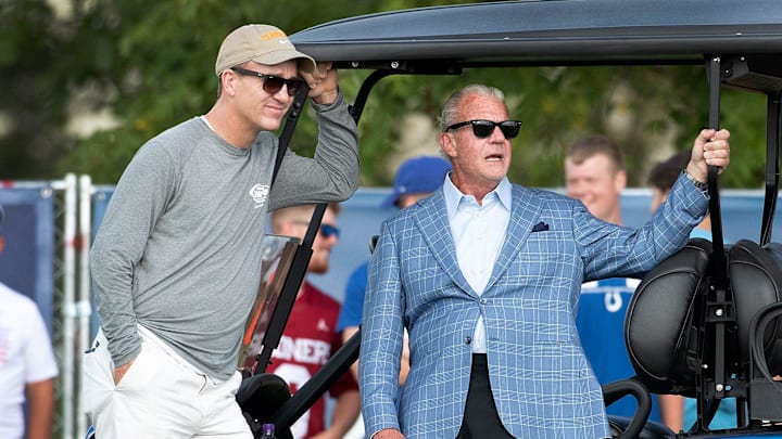 Manning and Jim Irsay watch a Colts practice.