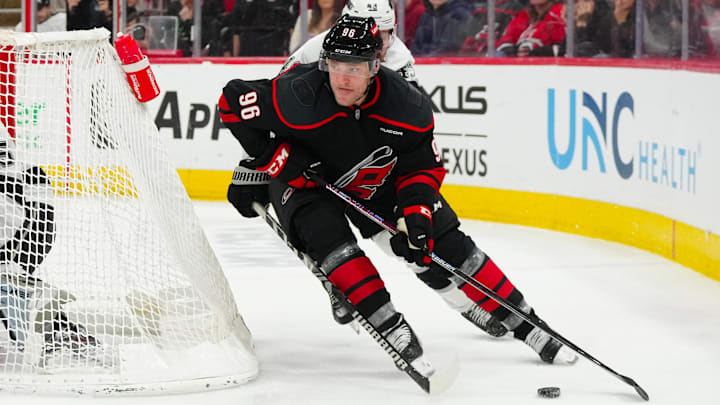 Feb 1, 2025; Raleigh, North Carolina, USA;  Carolina Hurricanes right wing Mikko Rantanen (96) skates with the puck against the Los Angeles Kings during the third period at Lenovo Center. Mandatory Credit: James Guillory-Imagn Images
