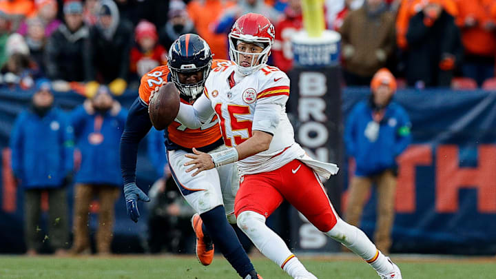 Oct 29, 2023; Denver, Colorado, USA; Kansas City Chiefs quarterback Patrick Mahomes (15) scrambles ahead of Denver Broncos defensive tackle Jonathan Harris (92) in the fourth quarter at Empower Field at Mile High. Mandatory Credit: Isaiah J. Downing-USA TODAY Sports