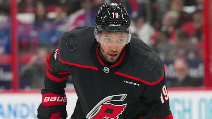 Oct 9, 2025; Raleigh, North Carolina, USA;  Carolina Hurricanes defenseman K'Andre Miller (19) looks on against the New Jersey Devils during the first period at Lenovo Center. Mandatory Credit: James Guillory-Imagn Images