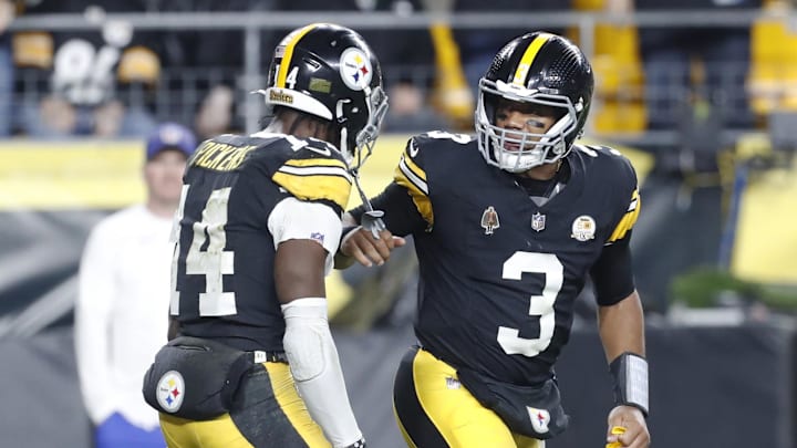 Oct 20, 2024; Pittsburgh, Pennsylvania, USA;  Pittsburgh Steelers wide receiver George Pickens (14) and Pittsburgh Steelers quarterback Russell Wilson (3) celebrate after combining for a touchdown against the New York Jets during the second quarter at Acrisure Stadium. Mandatory Credit: Charles LeClaire-Imagn Images