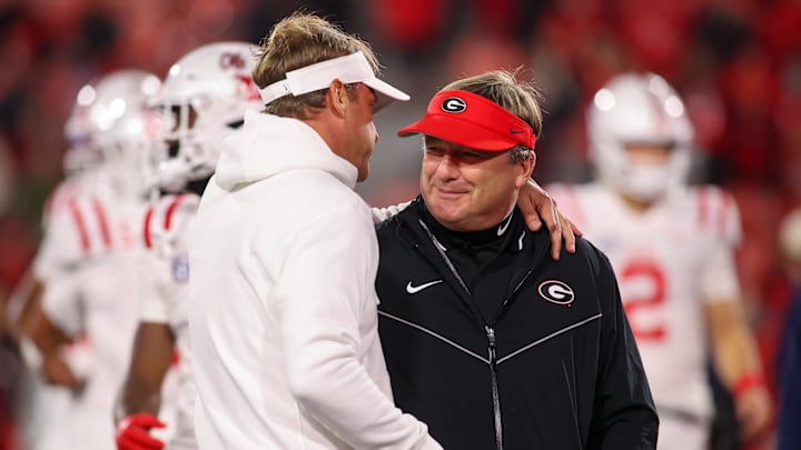 Nov 11, 2023; Athens, Georgia, USA; Mississippi Rebels head coach Lane Kiffin talks to Georgia Bulldogs head coach Kirby Smart before a game at Sanford Stadium. Mandatory Credit: Brett Davis-Imagn Images