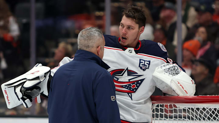 Dec 20, 2025; Anaheim, California, USA;  Columbus Blue Jackets goaltender Elvis Merzlikins (90) looks on as a team trainer checks on him during the second period against the Anaheim Ducks at Honda Center. Mandatory Credit: Kiyoshi Mio-Imagn Images