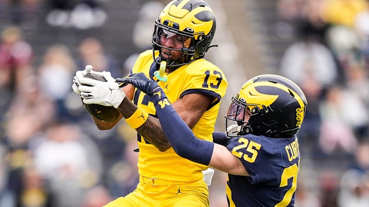 Team Maize wide receiver Donaven McCulley (13) makes a catch against Team Blue defensive back Mason Curtis (25) during the first half of the spring game at Michigan Stadium in Ann Arbor on Saturday, April 19, 2025. Team Maize wide receiver Donaven McCulley (13) makes a catch against Team Blue defensive back Mason Curtis (25) during the first half of the spring game at Michigan Stadium in Ann Arbor on Saturday, April 19, 2025.