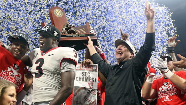 Dec 2, 2017; Atlanta, GA, USA; Georgia Bulldogs linebacker Roquan Smith (3) and head coach Kirby Smart celebrate on the podium following their victory over the Auburn Tigers 28-7 in the SEC Championship game at Mercedes-Benz Stadium. Mandatory Credit: Jason Getz-Imagn Images